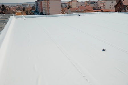 Michigan flat roofing maintenance preventing ponding water on low slope roofs